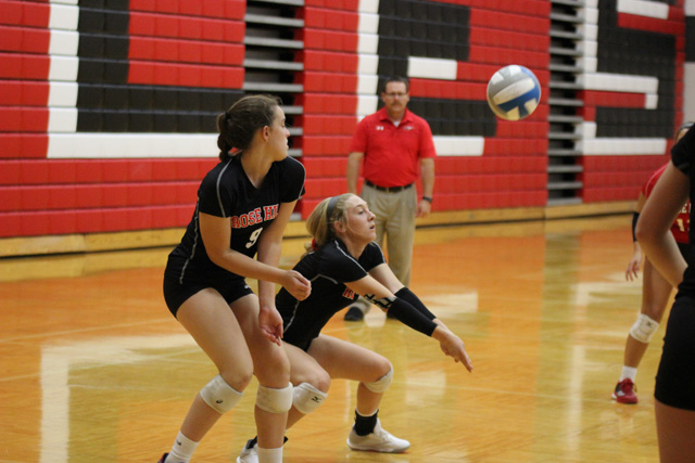 Aspen Goetz and Emily Adler try to dig out a return from Andover Central on Thursday, September 6. The Rockets defeated the Jaguars 25-12, 25-21