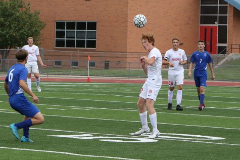 Caden Dinkel heads the ball in the Rockets 4-0 victory over Winfield of the Campus/Goddard Tournament. It was the Rockets first victory of the season.