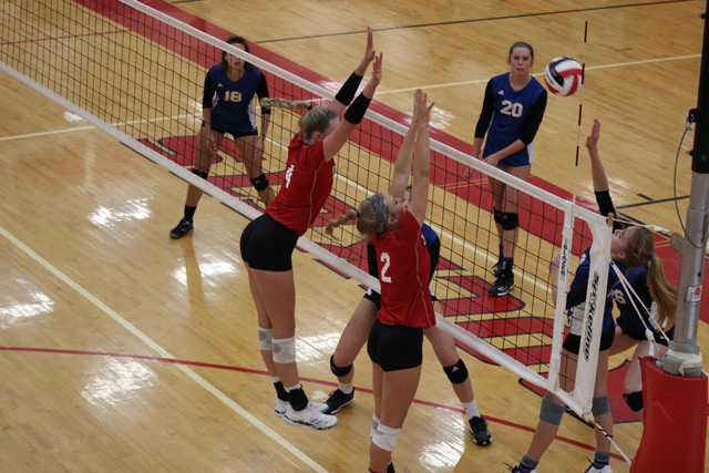 Gracie Van Driel and Breckyn Myers go up for a block against Collegiate on Tuesday, September 4. The Rockets defeated the Spartans 25-11 and 25-13.